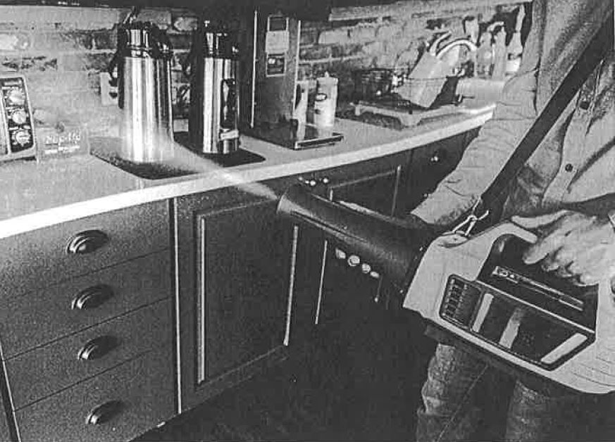 person spraying a fog onto a kitchen counter